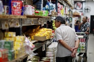 People shop in a supermarket, as Argentina is battling with an annual inflation heading towards 200%, in Buenos Aires, Argentina December 13, 2023. REUTERS/Agustin Marcarian