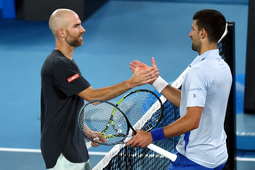 Tennis - Australian Open - Melbourne Park, Melbourne, Australia - January 21, 2024
Serbia's Novak Djokovic shakes hands with France's Adrian Mannarino after winning his fourth round match REUTERS/Edgar Su